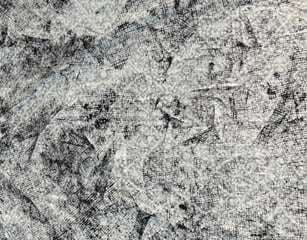 Layered grey and white spray textures on cotton.