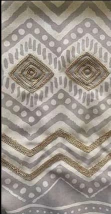 Grey zigzag print with gold dabka diamonds stitched over it.