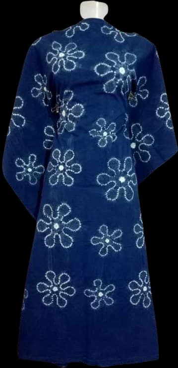 A kaftan dress scattered with white stitched flowers on indigo.