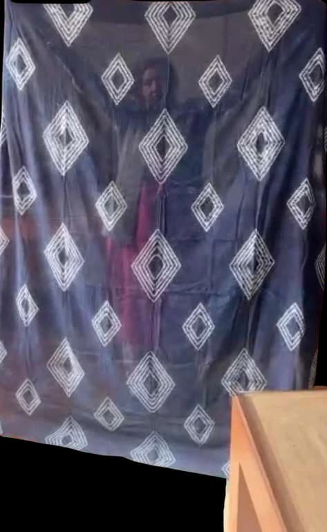 Soft blue fabric with white diamond resists.