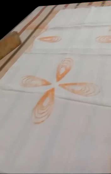 A four-petal stitched outline ready to be gathered.