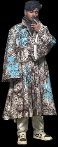 A long coat in a mottled, earthy surface with patches of bright blue.