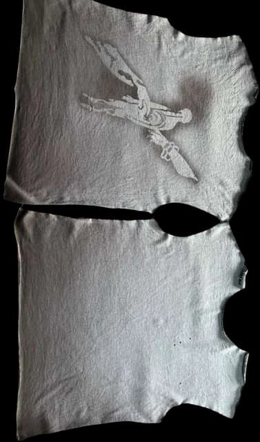 Two grey garment panels, stonewashed and sprayed through a stencil.